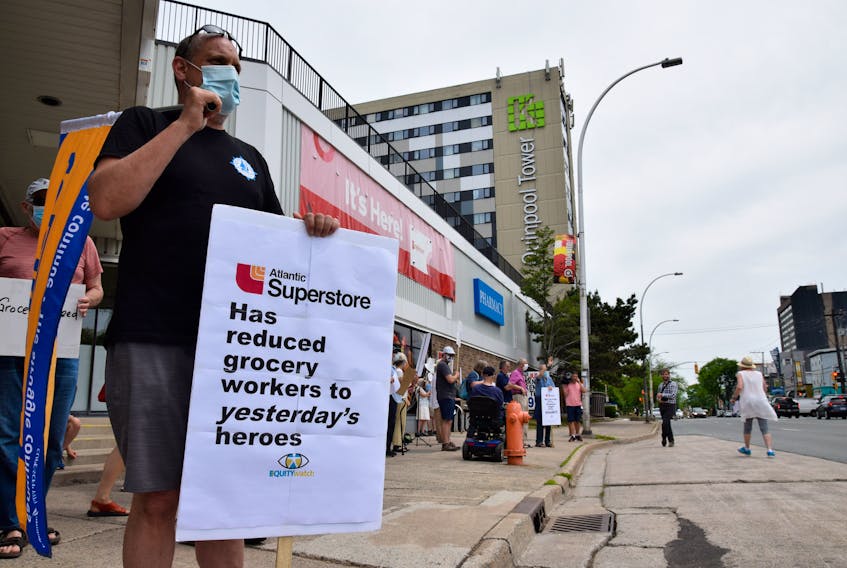 Jeff Callaghan, Canadian Union of Postal Workers' national director of Atlantic region, showed up to the Quinpool Road Atlantic Superstore in Halifax with a sign and union flag to protest wage cuts for Atlantic Superstore and Sobey's workers.