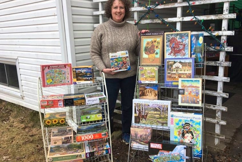 Angela Swanson gets ready for another day of puzzle trading as she sets up her Puzzle Library at 11 Main St. in Sackville, N.B.