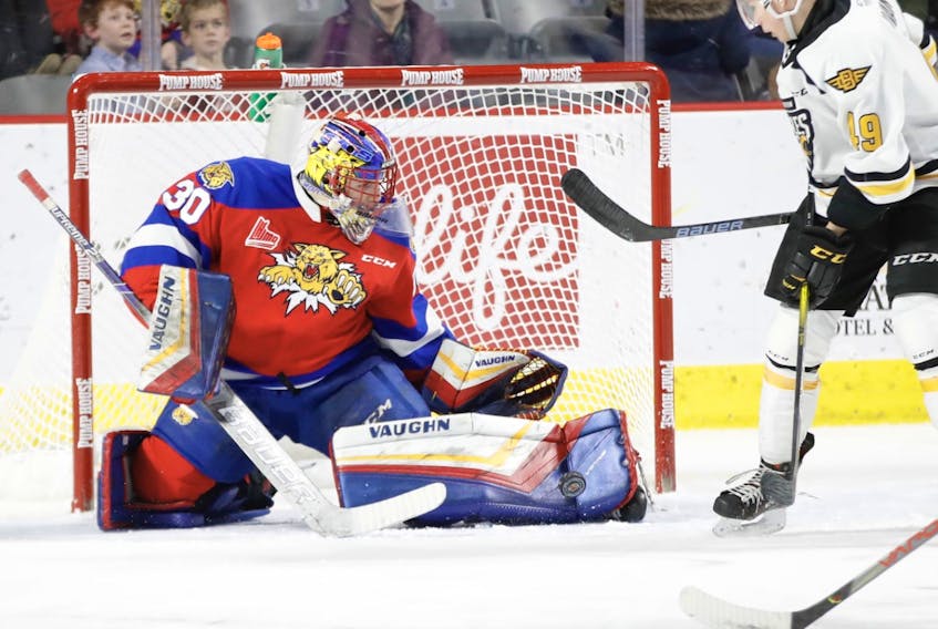 Charles-Antoine Lavallée of the Moncton Wildcats, left, makes one of his 23 saves on the night as Ivan Ivan of the Cape Breton Eagles looks for the rebound during Quebec Major Junior Hockey League action at the Avenir Centre on Friday. Moncton won the game 4-0. PHOTO/DANIEL ST. LOUIS