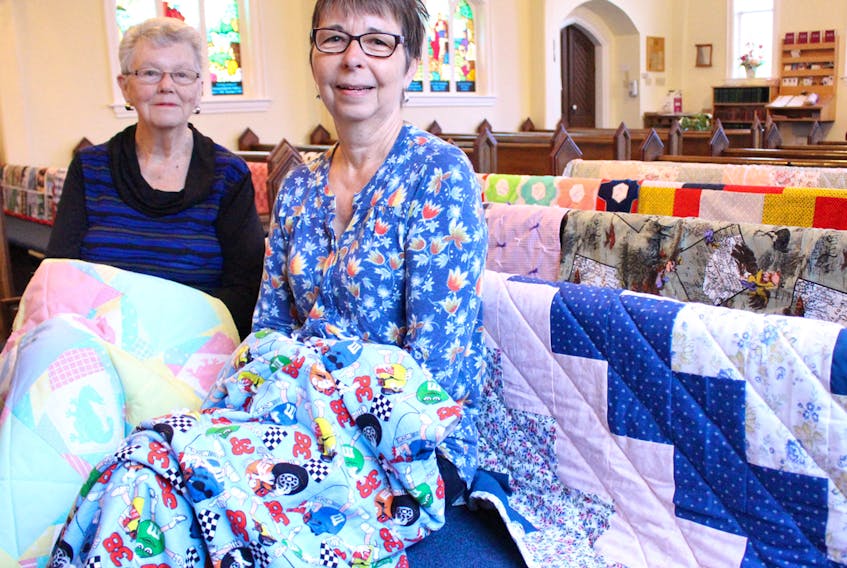 Doris Moase, left, and Amy McCarville are two of the members of the stitching group from the Anglican Parish of New London that made quilts for children and youth in the foster care system. Quilts will be on display at St. Mark’s Anglican Church in Kensington on Sunday at 11 a.m. The public is invited to attend. MILLICENT MCKAY/JOURNAL PIONEER