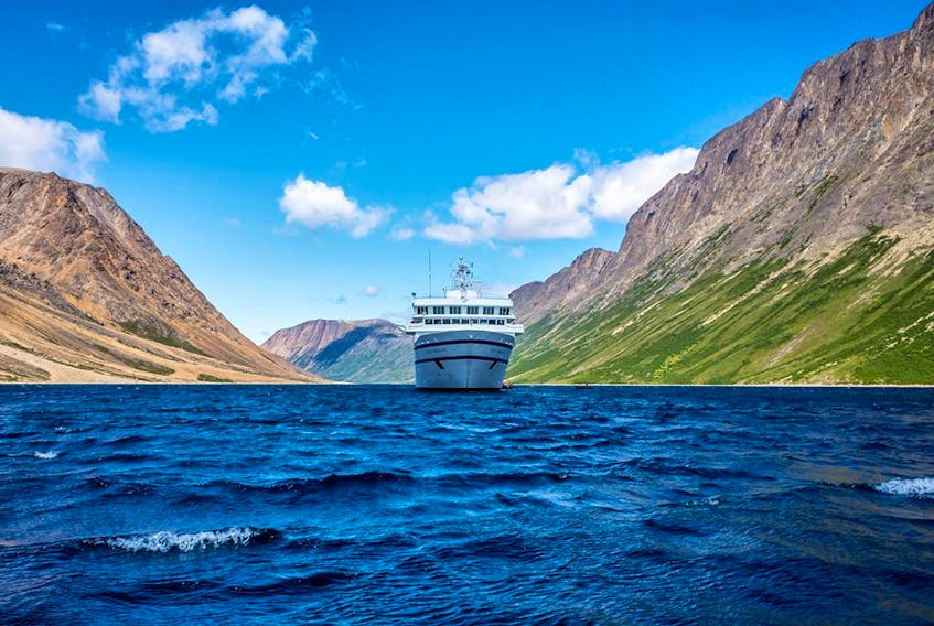 One Ocean Expeditions' ship the RCGS Resolute is shown sailing past the Torngat Mountains National Park, Newfoundland and Labrador.