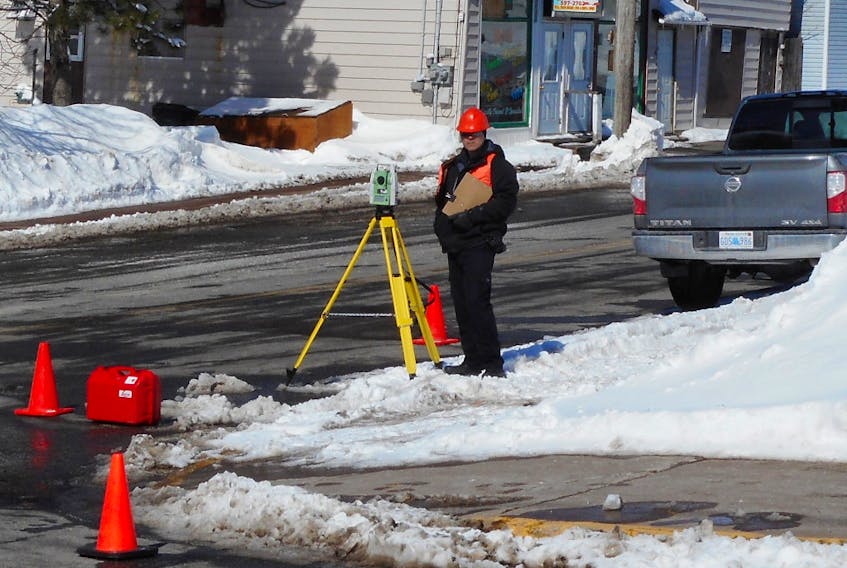 A member of the RCMP Northern Traffic Services disguised as a surveyor watches traffic at the top of Junction Road in Springhill.