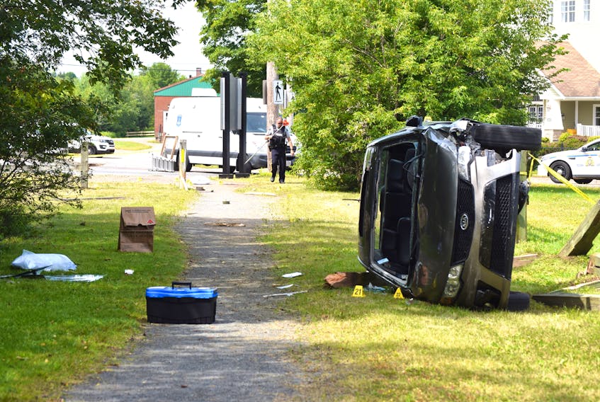 A Kia SUV is on its side on a trail off Willow Street in Truro after a fatal shooting by a police officer early Saturday. - Harry Sullivan/Truro News