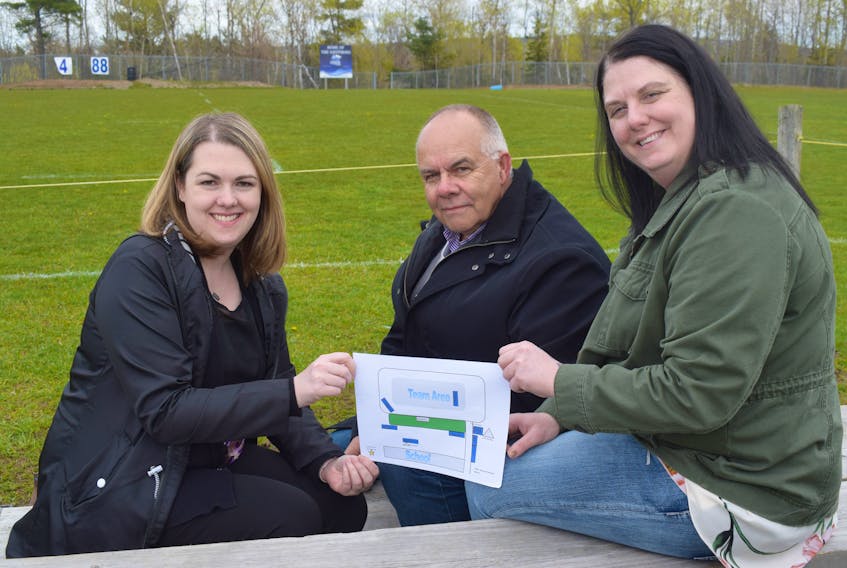 Media chair Angela Radcliffe, community champion Kevin Scott and logistics chair Shannon MacLean show an illustration of how the Pictou County Relay for Life will be set up this year at North Nova Education Centre.