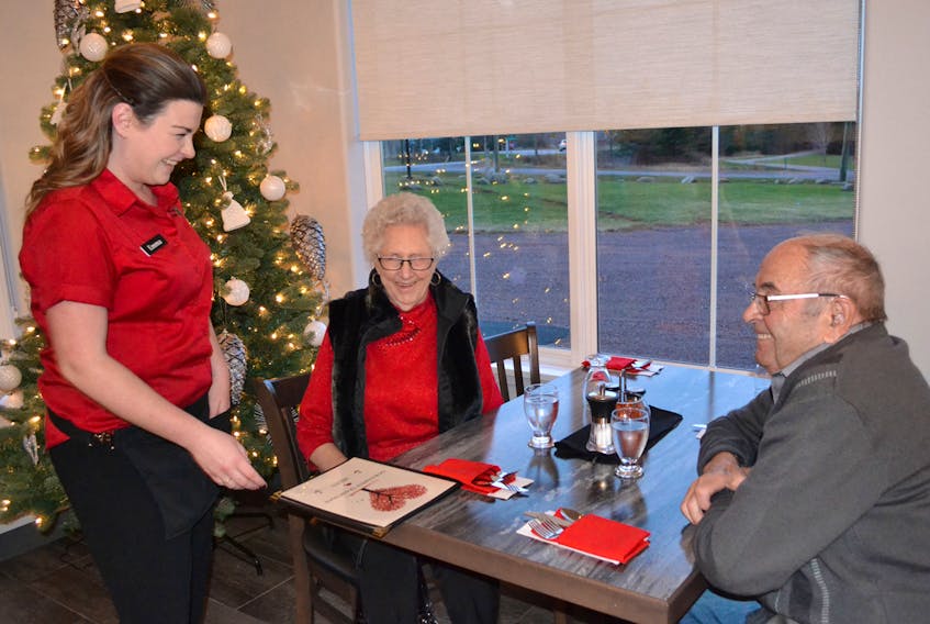 Waitress Emma McAlduff greets diners Goldie and Erskine MacMillan, back for their second meal since Our Family Traditions Restaurant opened in Tignish earlier this month. ERIC MCCARTHY/JOURNAL PIONEER