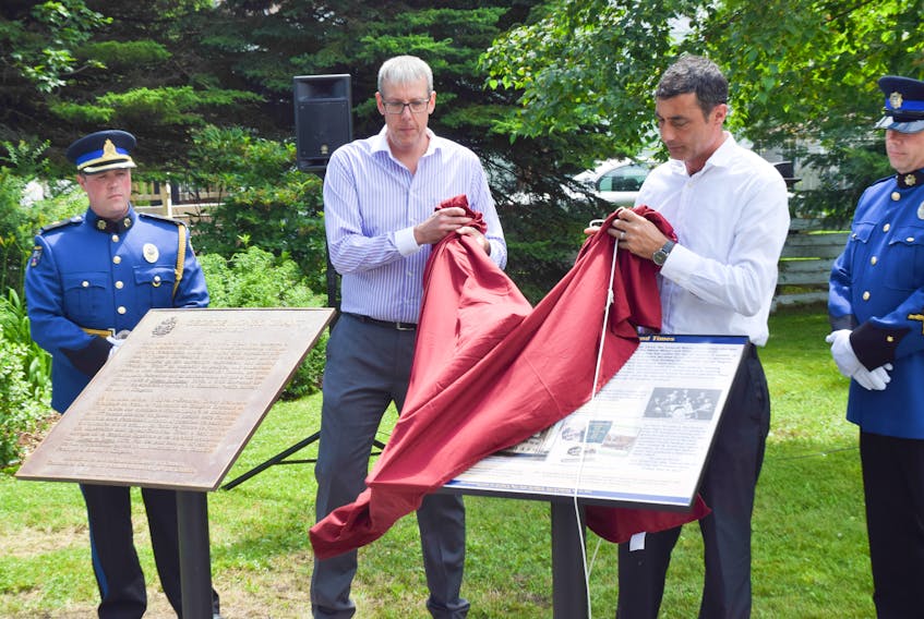 Stellarton Mayor Danny MacGillivray and councillor Simon Lawand unveil a panel telling the history of Rev. George Monro Grant.