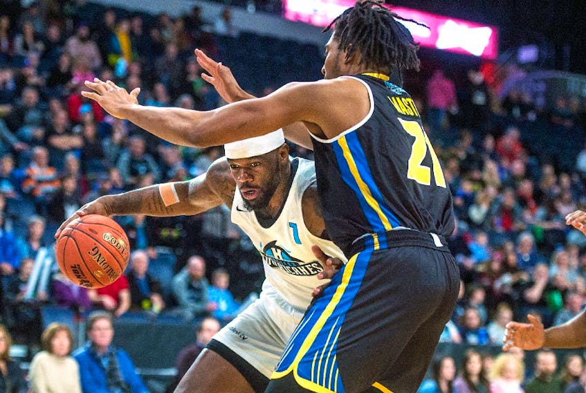Halifax Hurricanes forward Chadrack Lufile drives to the hoop against Saint John Riptide forward T.J. Maston during the first half of Saturday night’s NBL Canada game at the Scotiabank Centre. Saint John defeated Halifax 95-78. - RYAN TAPLIN