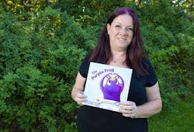 Author Angela Jeffreys holds a copy of her new children’s book The Purple Frog in Lower Sackville’s Acadia Park last month. The book is being translated into Mi’kmaq.