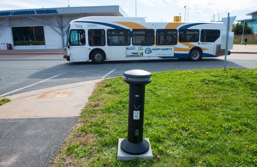 A bus passes behind a new ashtray installed in the designated smoking area at Lacewood Terminal on Monday. Halifax’s new smoking ban began Monday morning with smoking in municipally owned spaces restricted to areas approved by the municipality.
Ryan Taplin - The Chronicle Herald