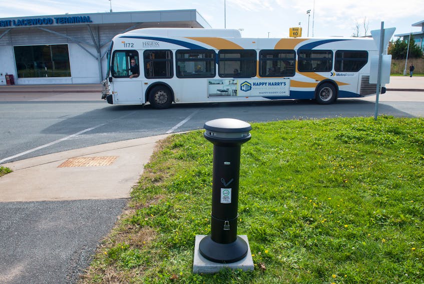 A bus passes behind a new ashtray installed in the designated smoking area at Lacewood Terminal on Monday. Halifax’s new smoking ban began Monday morning with smoking in municipally owned spaces restricted to areas approved by the municipality.
Ryan Taplin - The Chronicle Herald