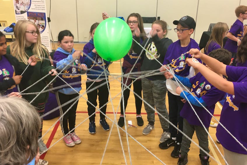 Grade 5 students from several elementary schools in Cumberland County participated in the annual Racing Against Drugs program that was hosted this year at Cumberland North Academy. One of the activities included balancing a ball on strings of yarn to keep it from falling to the floor.