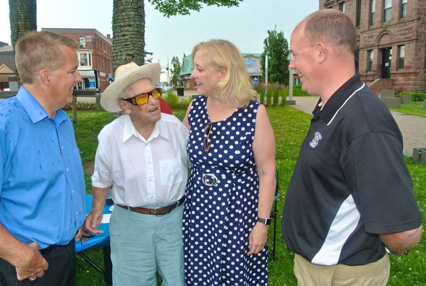 Deputy federal Conservative leader Lisa Raitt speaks with former premier Roger Bacon, Cumberland-Colchester Conservative candidate Scott Armstrong (left) and Cumberland South MLA Tory Rushton (right) during a stop in Amherst on July 21.