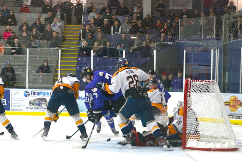 The Ramblers and Mariners battle for the puck in front of the Mariners net Thursday night at Amherst Stadium.