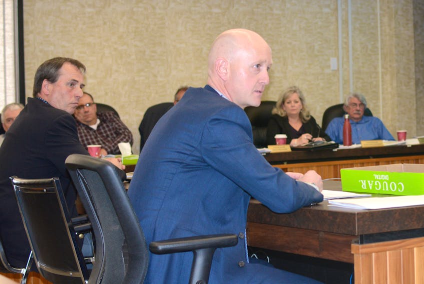 Mac Davis, right, and Ian Ripley addressed councillor Lynne Welton’s concerns about clear-cut logging after they gave a presentation on behalf of the 40 forestry workers who packed into the Cumberland County council chambers on May 1.