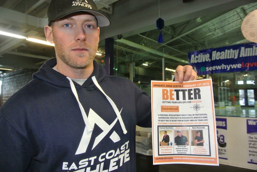 Ryan Reynolds of East Coast Athlete holds up a poster for a Be Better seminar at the Susan Taylor Theatre at ARHS on Friday, Feb. 1 at 6:30 pm.
