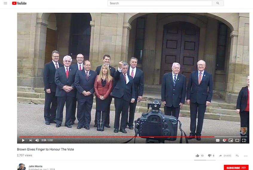 In this screenshot of a video posted to YouTube by P.E.I. photographer John Morris, Liberal MLA Richard Brown is shown giving the middle finger to a member of the public during a 2016 photoshoot for a government Christmas card.