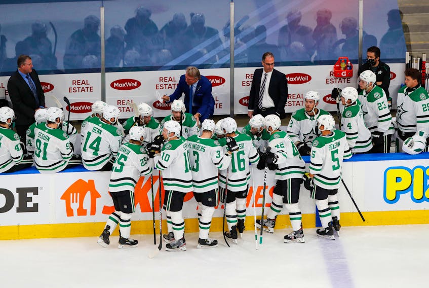 Dallas Stars head Rick Bowness, centre, talks to his team during a timeout in NHL playoff action. Bowness, of Halifax, has led the Stars to the Stanley Cup Final. Reuters