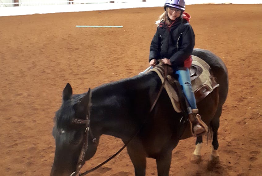Ten-year-old Abigail Cholmondeley, who is autistic and visually impaired, has been taking part in the therapeutic riding program at Forever Memories Equestrian Centre for about a year. She has formed a close bond with her favourite horse, Slice.