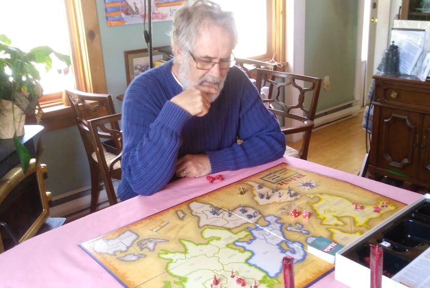 Dartmouth Heritage Museum manager Terry Eyland plays Risk remotely with an old high school buddy who lives far away while in social isolation at his home in Hubley in March 2020.