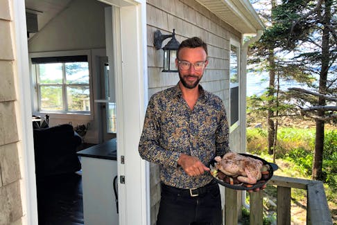 Robert Goldsworthy delivering a roast chicken dinner from our Gourmet To Go menu to Grey Owl, one of our oceanfront cottages.