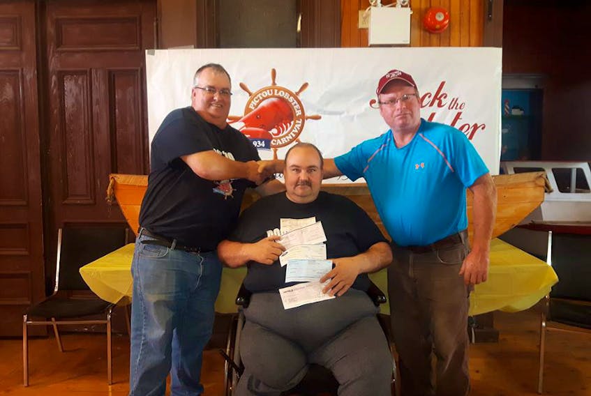 Fishermen from all the wharfs in the area of 26a presented checks totaling in excess of $6,000 to the Pictou Lobster Carnival committee chairperson Shawn McNamara and media relations officer Kent Corbett.