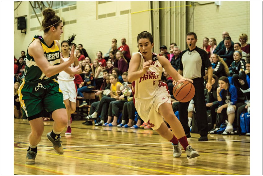 Memorial Athletics photo/Joe Kissusi — Rosie Stanoev (right) of the Memorial Sea-Hawks moves the ball up the floor during an exhibition basketball game against the University of Alberta last weekend at the Field House in St. John’s. The Sea-Hawk women continue their pre-season schedule in Quebec City this weekend, while the Memorial men are also on the road, competing in an exhibition tourney in Edmonton.