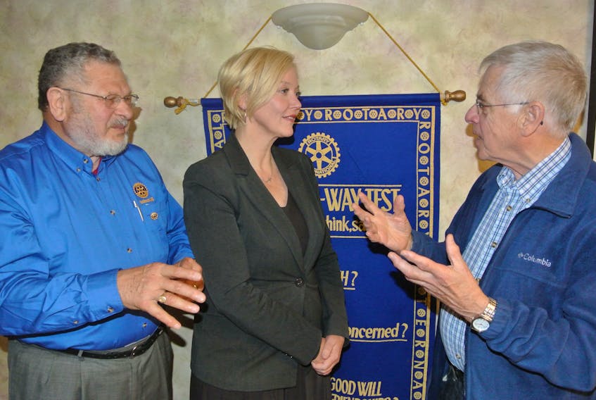 Cumberland North MLA Elizabeth Smith-McCrossin talks to Rotarians Morris Haugg (left) and David Myles following a recent meeting of the Amherst Rotary Club.