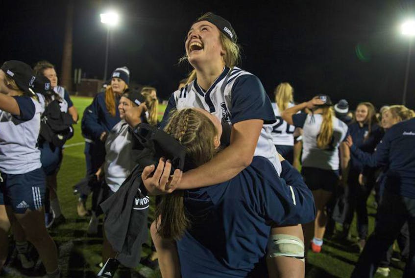 Alexandra Hamilton and her St. Francis Xavier teammates celebrate their 41-24 win over the Guelph Gryphons in Sunday’s U Sports women’s rugby championship final at Acadia.