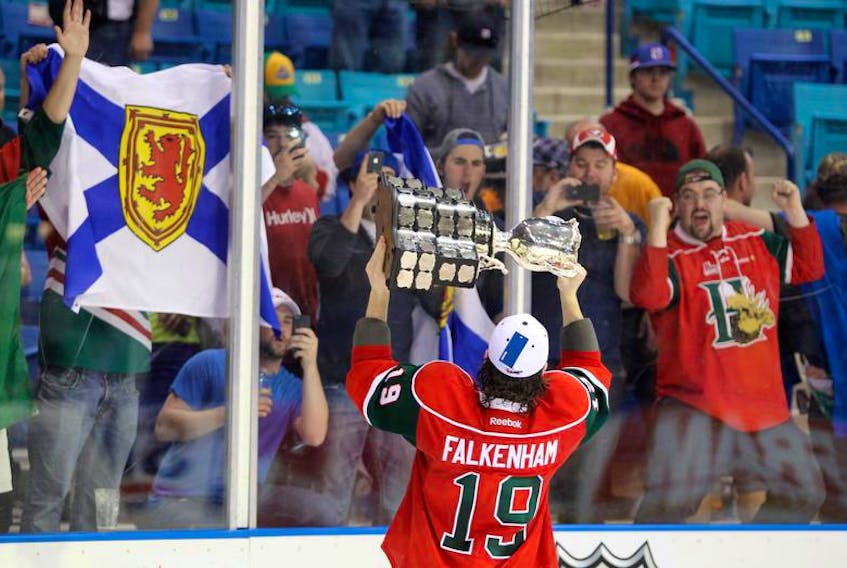 Halifax Mooseheads winger Ryan Falkenham shows off the championship trophy to jubilant Halifax fans as they celebrate their 6-4 win over the Portland Winterhawks in the final of the Memorial Cup in Saskatoon on May 26, 2013. Falkenham is now an assistant coach with the Drummondville Voltigeurs.