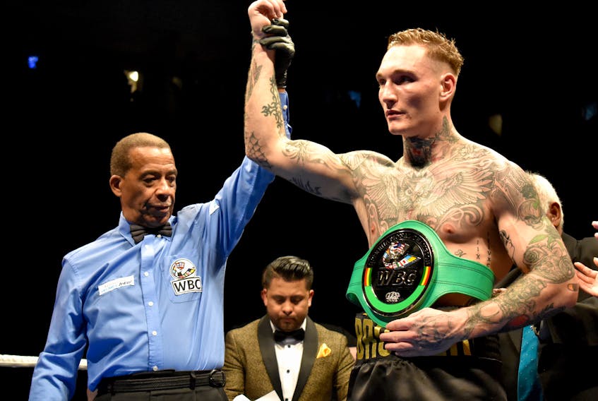Referee Hubert Earle, left, lifts the arm of Ryan (The Bruiser) Rozicki after the 24-year-old Sydney Forks professional boxer captured the WBC International Silver cruiserweight championship, defeating Shawn Miller with a third round knockout at Centre 200 on Saturday. The title is Rozicki's third championship win in less than a year.