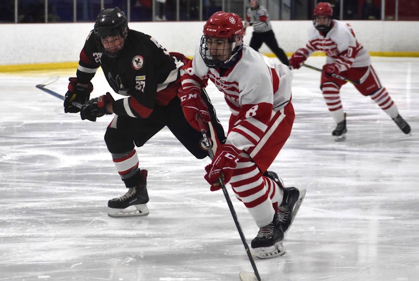 Brady Lavin of the Riverview Redmen, right, breaks into the offensive zone as he's chased by Maclean Tobin of the Northumberland Nighthawks during Red Cup Showcase action at the Cape Breton County Recreation Centre on Saturday. Riverview won the game 2-1 in overtime.
