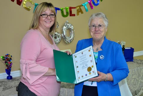 Tracey Moores, left, presents a certificate on behalf of MP Churence Rogers to Sister Gladys Bozic.
