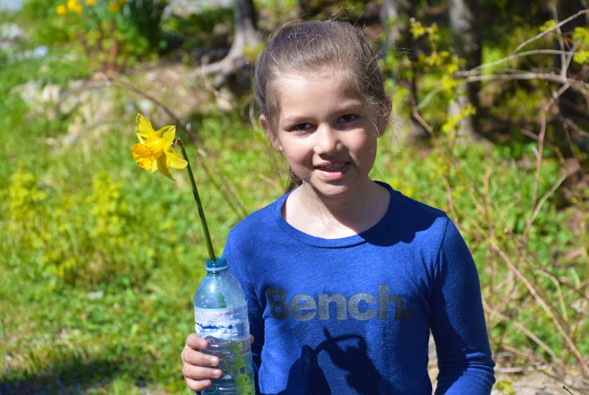 Nine-year-old Paige Cumben made sure her daffodil had plenty to drink as she was leaving the “Come Pick a Daffodil” fundraiser on Sunday, May 27.