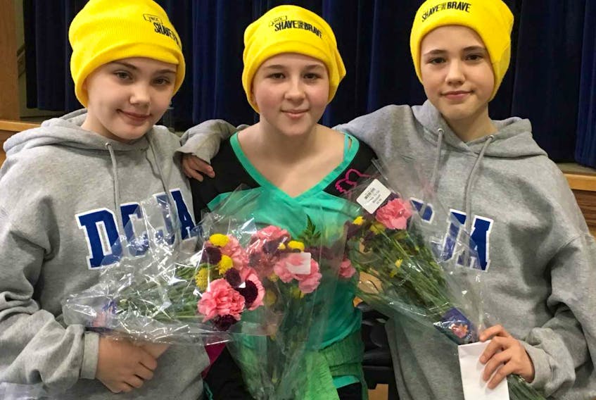 Three students from Donald C. Jamieson Academy in Burin said goodbye to their long locks to help raise funds through the Shave for the Brave. Pictured, from left, are Taylor Crocker, Samantha Hollett and Olivia Farrell.