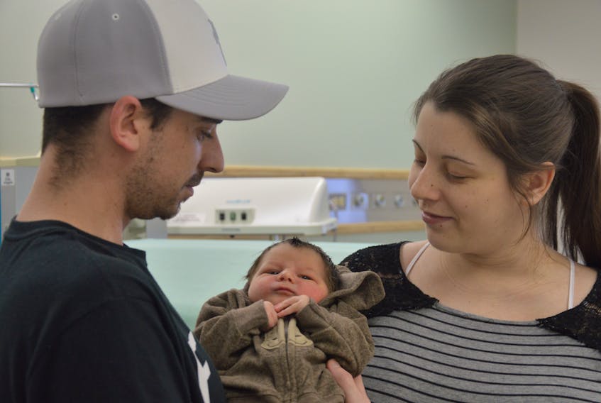Gus Slaney and Ashley Brown look lovingly at their newborn son Ayden, the first baby born on the Burin Peninsula in 2019.