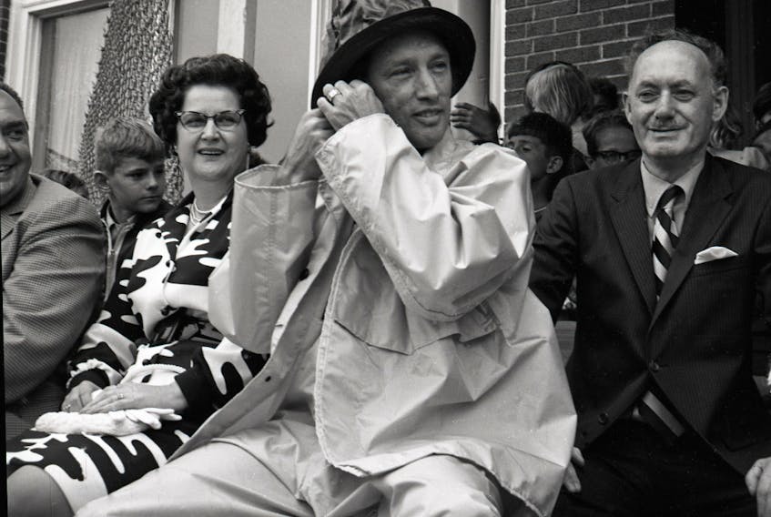 Prime Minister Pierre Elliott Trudeau donned oilskins and a sou’wester during his visit to Fortune in August of 1971. From left, the Hon. Donald C. Jamieson, Mrs. Marjorie Matthews (wife of Mayor Tobias Matthews), Mr. Trudeau and Harvey Maugher, manager of the Booth Fisheries Ltd. fish plant at Fortune.