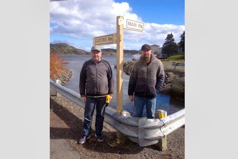 Local service district chair Robert Mitchell, left, and member Isaac McConnell at one of Epworth’s street signs.