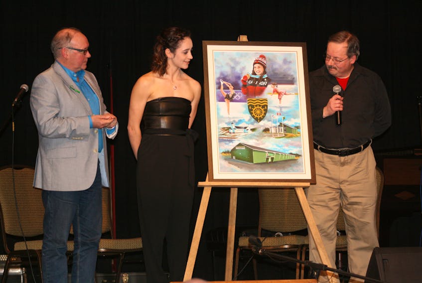 Kaetlyn Osmond was presented with an original painting by local artist Jim Miles (right) on April 14. The painting was commissioned by the Town of Marystown. Mayor Sam Synard also took part in the presentation.