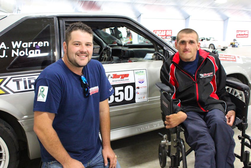 Andrew Warren helped out the members of 2IntentsRacing after the car driven by Kevin Chaulk was involved in an accident during an event in Flat Rock. Left to right are driver Andrew Warren, and navigator Jason Nolan.
