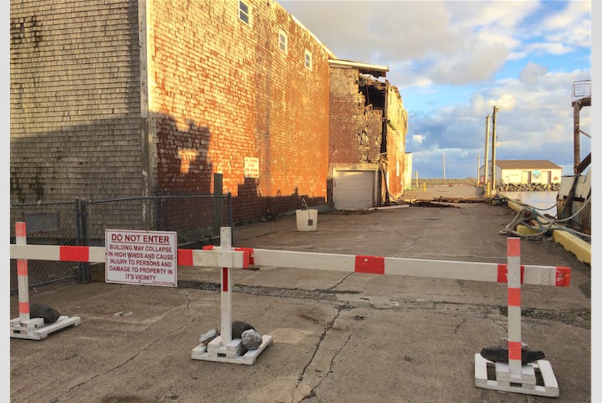 The area around the Sea King portion of the Samuel J. Harris Building on Grand Bank’s waterfront has been blockaded to obstruct public access. The condition of the building has been steadily deteriorating, and on Sunday, Oct. 21 high winds damaged the structure further.