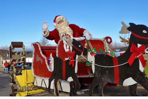 Santa Claus waves to an adoring audience at the parade in St. Lawrence. - Cynthia Farrell