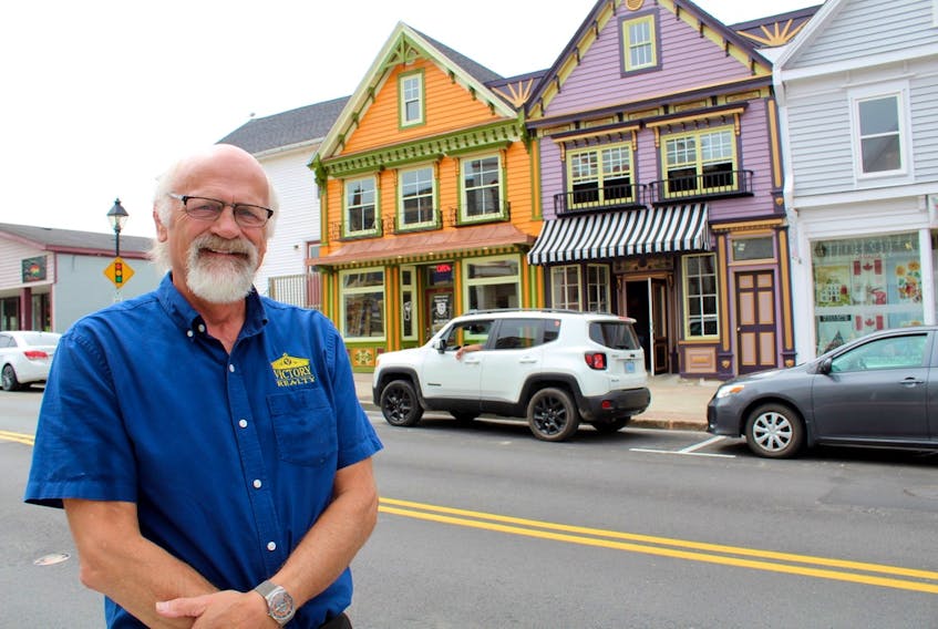 Yarmouth businessman Richard LeBlanc stands in front of two buildings he dramatically transformed on Main Street.