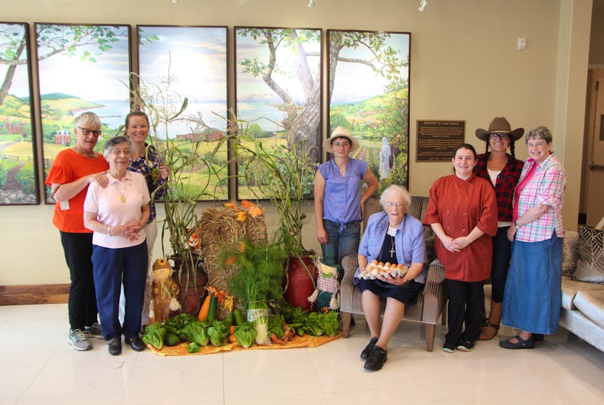 Tat MacKinnon, Sister Dolores Sogz, Candace MacKenzie, Maria Vanberkel, Sr. Margaret Landry, Melissa Muir, Lari-Lynn Stewart, and Sister Sandra Cooke, posing with the ingredients that went into a locally sourced meal at Parkland Antigonish, on Sept. 14.