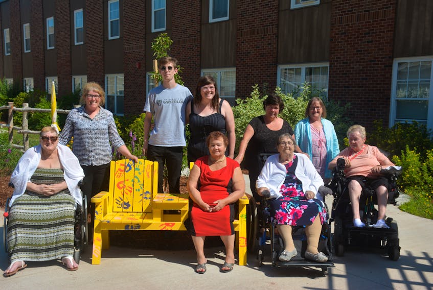 Kim Cameron-MacDonald (upper left), Francis Grenier, Emma MacDonald, Mary Grace, Mary Partridge, Diane Delorey (bottom left), Donna MacLean, Mary Margaret Grace and Sadie Hadley – all enjoying the fine weather with the Buddy Bench – the newest addition to the garden area of the RK MacDonald Nursing Home.