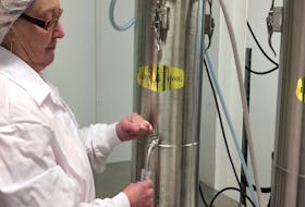 A member of staff at the Clever Fruit Products test lab, at the Perennia facility in Truro, performing one of a gauntlet of tests on a fermented blueberry product the company is looking to sell as a nutritional supplement.
