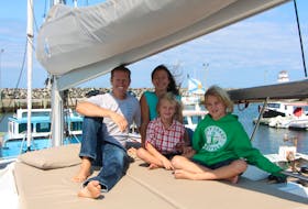 Brad and Karen Cook, and their two sons, Charlie and Ben, aboard the Hangtime, a 47-foot catamaran. The family spent the summer sailing around the Maritime provinces, living full-time aboard their boat.