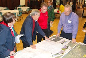 Members of the public and representatives of Nova Scotia Transportation and Infrastructure Renewal discuss a proposed route for a new, twinned section of Highway 104, from Antigonish to Sutherland’s River.