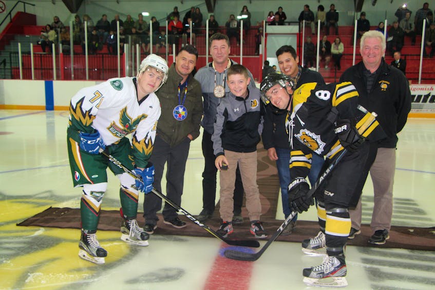 Chiefs Leroy Denny and Paul (PJ) Prosper, former Antigonish Farmers’ Mutual Junior Bulldog Cory Julian, and former league president Miles Tompkins at the ceremonial puck drop prior to the Eskasoni Eagles’ first regular season game in the Nova Scotia Junior Hockey League. Prior to the game Cohen Pictou, a member of the Antigonish Minor Hockey Association, flanked by Eagle Thomas Simon, (left) and Bulldog Devin MacLaughlin, was given the honour of dropping the puck.