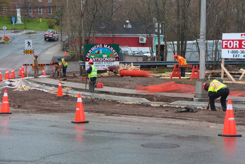 Crew members working on a new sidewalk for the intersection between Main and Hawthorne.