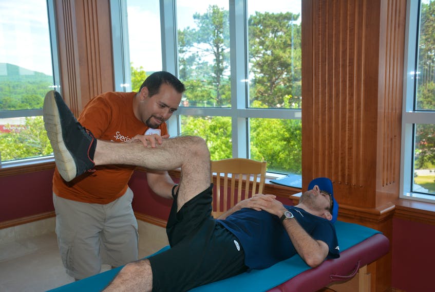 JR Marshall, a clinical director of Fun Fitness tests the flexibility of Team Quebec athlete Simon Houle. Fun Fitness was one of many specialized medical services offered to athletes throughout the week of the 2018 Special Olympics Summer Games in Antigonish.
